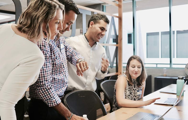 to menn og to kvinner ser på to pcer