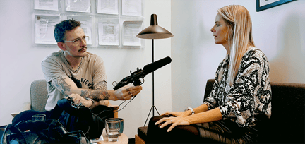 mann og kvinne med en mikrofon mellom seg